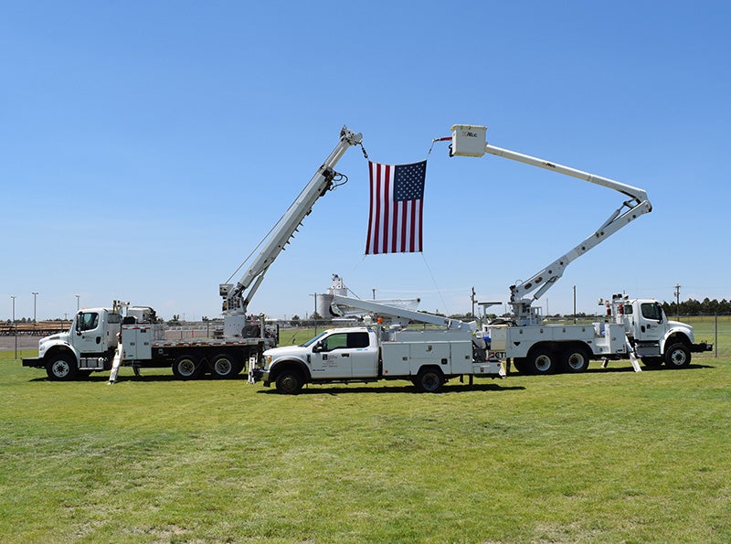 Annual Meeting Bucket Trucks with Flag